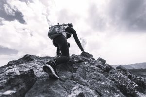 A female rock climbing in the mountains.